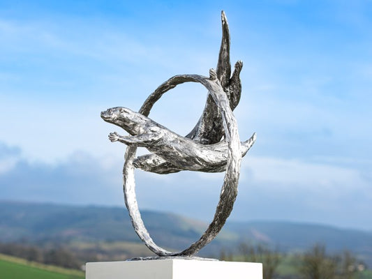 ‘THROUGH CLEAR WATER’ OTTERS SWIMMING THROUGH RING SCULPTURE